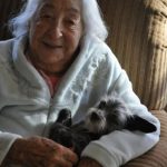 93 year old woman with dog in arms